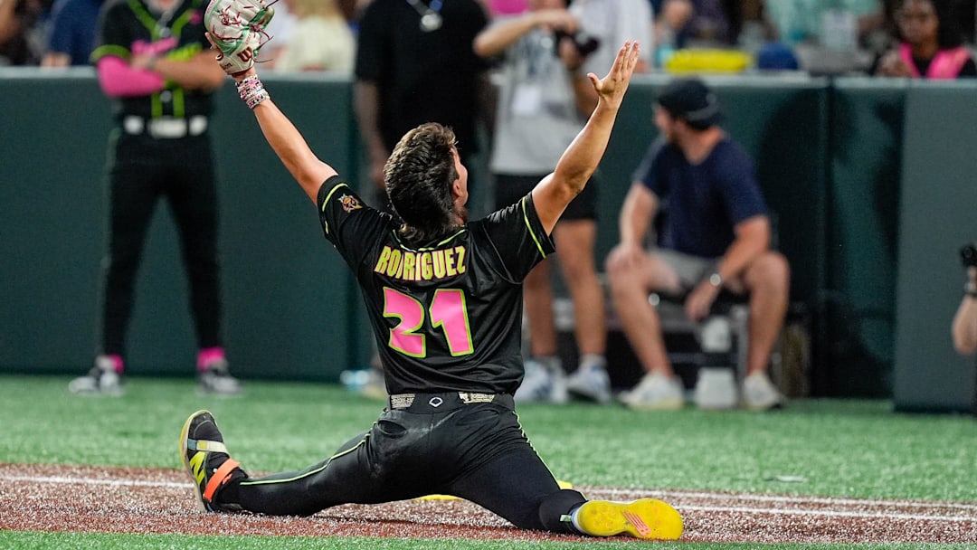 Jun 7, 2025; Charlotte, NC, USA; Party Animals pitcher Riyan Rodriguez (21) celebrates making a pop fly catch against the Savannah Bananas during the exhibition game at Bank of America Stadium. Mandatory Credit: Jim Dedmon-Imagn Images