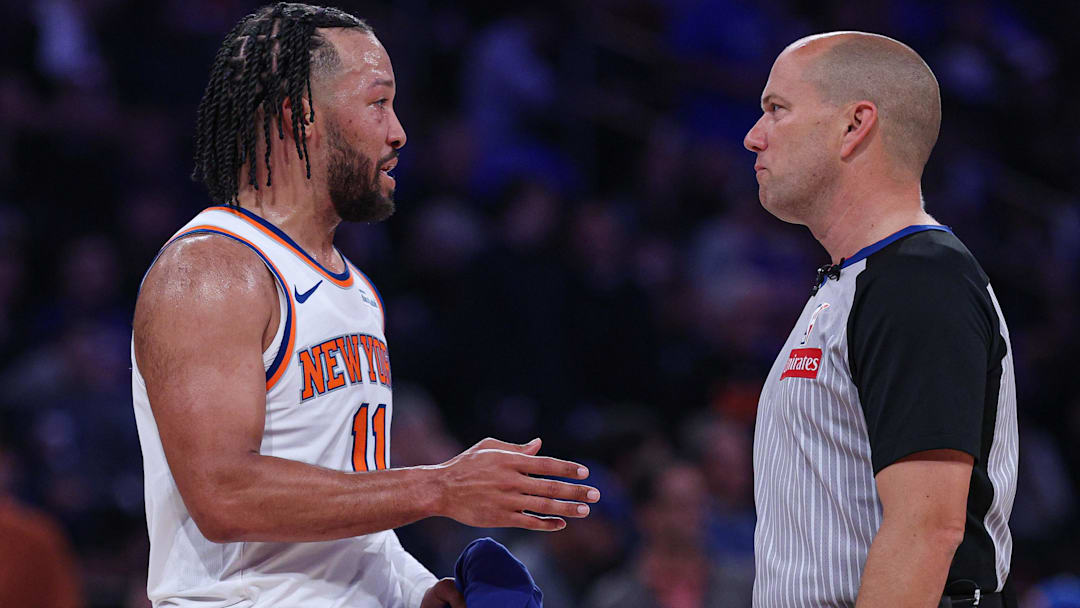 Knicks guard Jalen Brunson talks with a referee.
