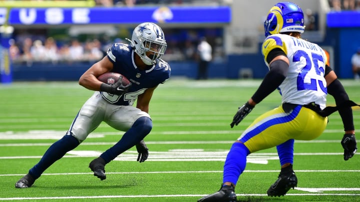 Aug 11, 2024; Inglewood, California, USA; Dallas Cowboys running back Malik Davis (34) runs the ball against Los Angeles Rams safety Jason Taylor II (25) during the first half at SoFi Stadium. Mandatory Credit: Gary A. Vasquez-USA TODAY Sports