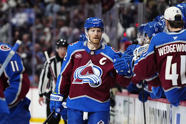 Hockey player celebrates goal with teammate
