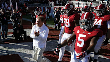 Nick Saban leads the Alabama football team onto the field. The University of Alabama has decided to rename the field in honor of Saban.