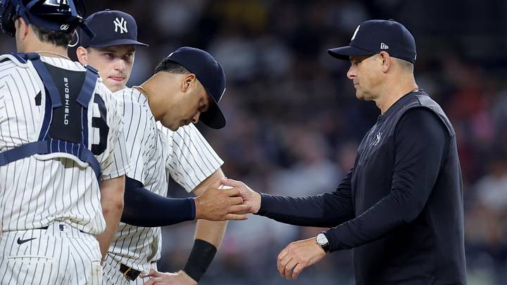 New York Yankees manager Aaron Boone (17) takes the ball from relief pitcher Fernando Cruz (63)
