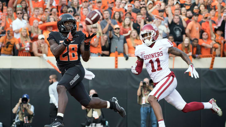 Nov 4, 2017; Stillwater, OK, USA; Oklahoma State Cowboys wide receiver James Washington (28) makes a catch for a touchdown while defended by Oklahoma Sooners cornerback Parnell Motley (11) during the first half at Boone Pickens Stadium. Mandatory Credit: Rob Ferguson-USA TODAY Sports