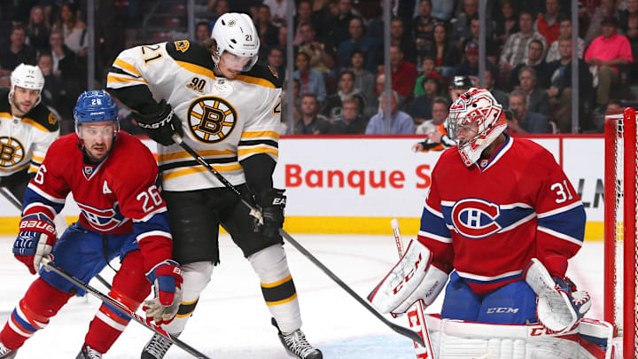 May 12, 2014; Montreal, Quebec, CAN; Montreal Canadiens defenseman Josh Gorges (26) helps goalie Carey Price (31) to make a save against Boston Bruins left wing Loui Eriksson (21) during the second period in the game six of the second round of the 2014 Stanley Cup Playoffs at Bell Centre. Mandatory Credit: Jean-Yves Ahern-Imagn Images