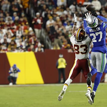 Nov 2, 2025; Landover, Maryland, USA;  Seattle Seahawks cornerback Riq Woolen (27) attempts to intercept a pass for Washington Commanders wide receiver Jaylin Lane (83) during the third quarter at Northwest Stadium. Mandatory Credit: Geoff Burke-Imagn Images