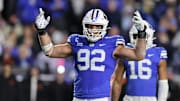 Oct 18, 2024; Provo, Utah, USA; Brigham Young Cougars defensive end Tyler Batty (92) encourages fans to cheer against the Oklahoma State Cowboys during the fourth quarter at LaVell Edwards Stadium. Mandatory Credit: Rob Gray-Imagn Images