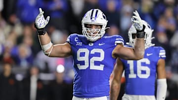 Oct 18, 2024; Provo, Utah, USA; Brigham Young Cougars defensive end Tyler Batty (92) encourages fans to cheer against the Oklahoma State Cowboys during the fourth quarter at LaVell Edwards Stadium. Mandatory Credit: Rob Gray-Imagn Images