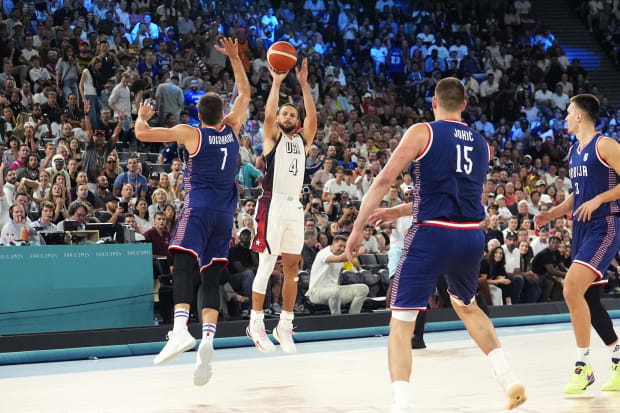 USA guard Stephen Curry shoots the ball against Serbia in the Olympics.