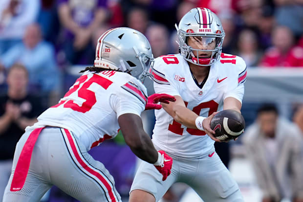 Ohio State quarterback Julian Sayin hands off to running back Bo Jackson.