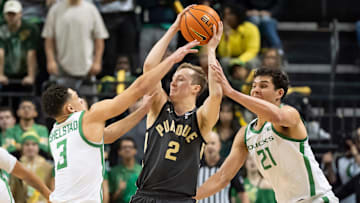 Oregon forward Brandon Angel, right, and guard Jackson Shelstad, left, attempt to foul Purdue guard Fletcher Loyer in the final moments of the game as the Oregon Ducks host the Purdue Boilermakers Saturday, Jan. 18, 2025, at Matthew Knight Arena in Eugene, Ore.