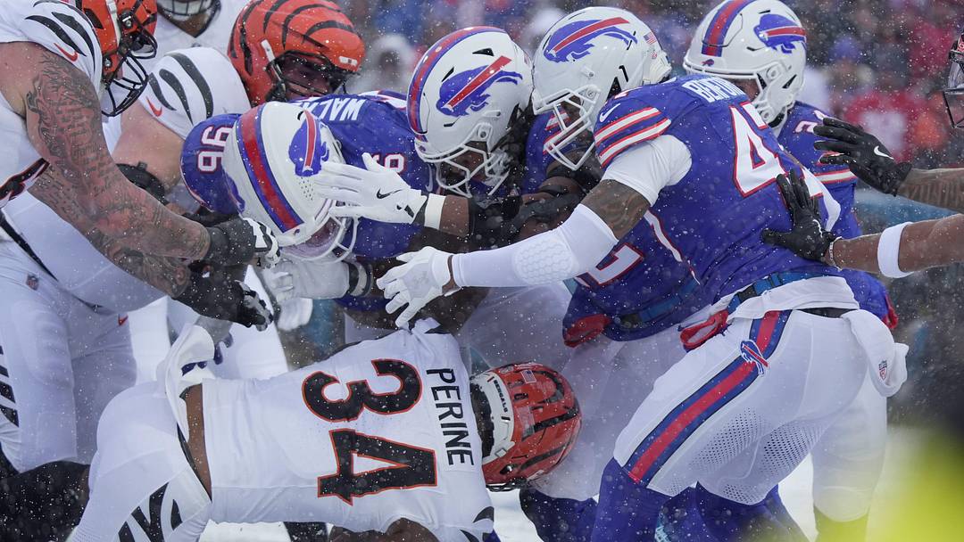 Cincinnati Bengals running back Samaje Perine heads into a wall of Bills players, including defensive tackle Deone Walker, during first-half action at Highmark Stadium in Orchard Park on Dec. 7, 2025.