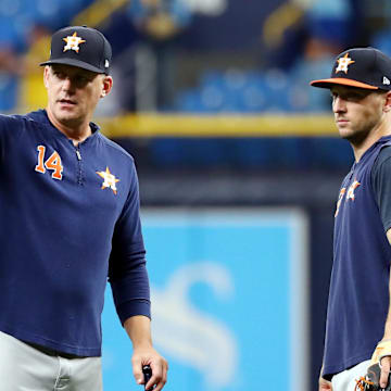 Oct 7, 2019; St. Petersburg, FL, USA; Houston Astros manager AJ Hinch (14) talks with third baseman Alex Bregman (2) during warmups before the game against the Tampa Bay Rays in game three of the 2019 ALDS playoff baseball series at Tropicana Field. 