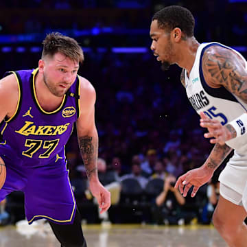 Feb 25, 2025; Los Angeles, California, USA; Los Angeles Lakers guard Luka Doncic (77) dribbles the ball against Dallas Mavericks forward P.J. Washington (25) during the second half at Crypto.com Arena. Mandatory Credit: Gary A. Vasquez-Imagn Images