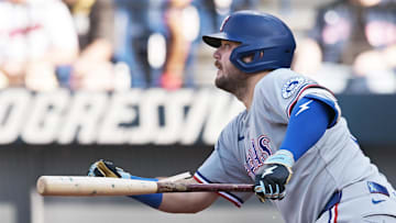Texas Rangers first baseman Jake Burger (21) hits an RBI single during the third inning against the Cleveland Guardians at Progressive Field. 