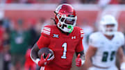 Utah Utes running back Wayshawn Parker (1) runs for a touchdown against the Cal Poly Mustangs during the second half at Rice-Eccles Stadium. 