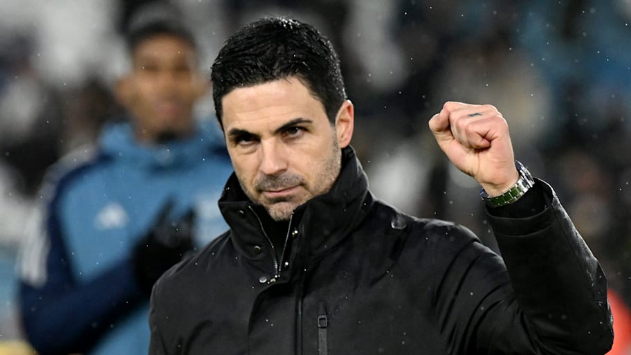Mikel Arteta raising a clenched fist.