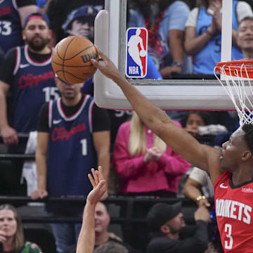 Apr 9, 2025; Inglewood, California, USA; Houston Rockets center N'Faly Dante (3) block Los Angeles Clippers guard Bogdan Bogdanovic (10) in the second half at Intuit Dome. Mandatory Credit: Kirby Lee-Imagn Images