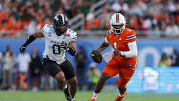 Dec 28, 2024; Orlando, FL, USA; Miami Hurricanes quarterback Cam Ward (1) runs with the ball against the Iowa State Cyclones in the second quarter during the Pop Tarts bowl at Camping World Stadium. Mandatory Credit: Nathan Ray Seebeck-Imagn Images