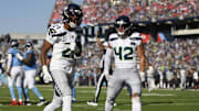 Nov 23, 2025; Nashville, Tennessee, USA; Seattle Seahawks cornerback Devon Witherspoon (21) celebrates after a sack with linebacker Drake Thomas (42) during the first half against the Tennessee Titans at Nissan Stadium.
