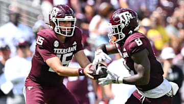 Oct 5, 2024; College Station, Texas, USA; Texas A&M Aggies quarterback Conner Weigman (15) hand off the ball to running back Le'Veon Moss (8) in the second half against the Missouri Tigers at Kyle Field. Mandatory Credit: Maria Lysaker-Imagn Images. 