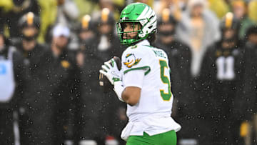 Nov 8, 2025; Iowa City, Iowa, USA; Oregon Ducks quarterback Dante Moore (5) looks to throw a pass against the Iowa Hawkeyes during the first quarter at Kinnick Stadium. Mandatory Credit: Jeffrey Becker-Imagn Images