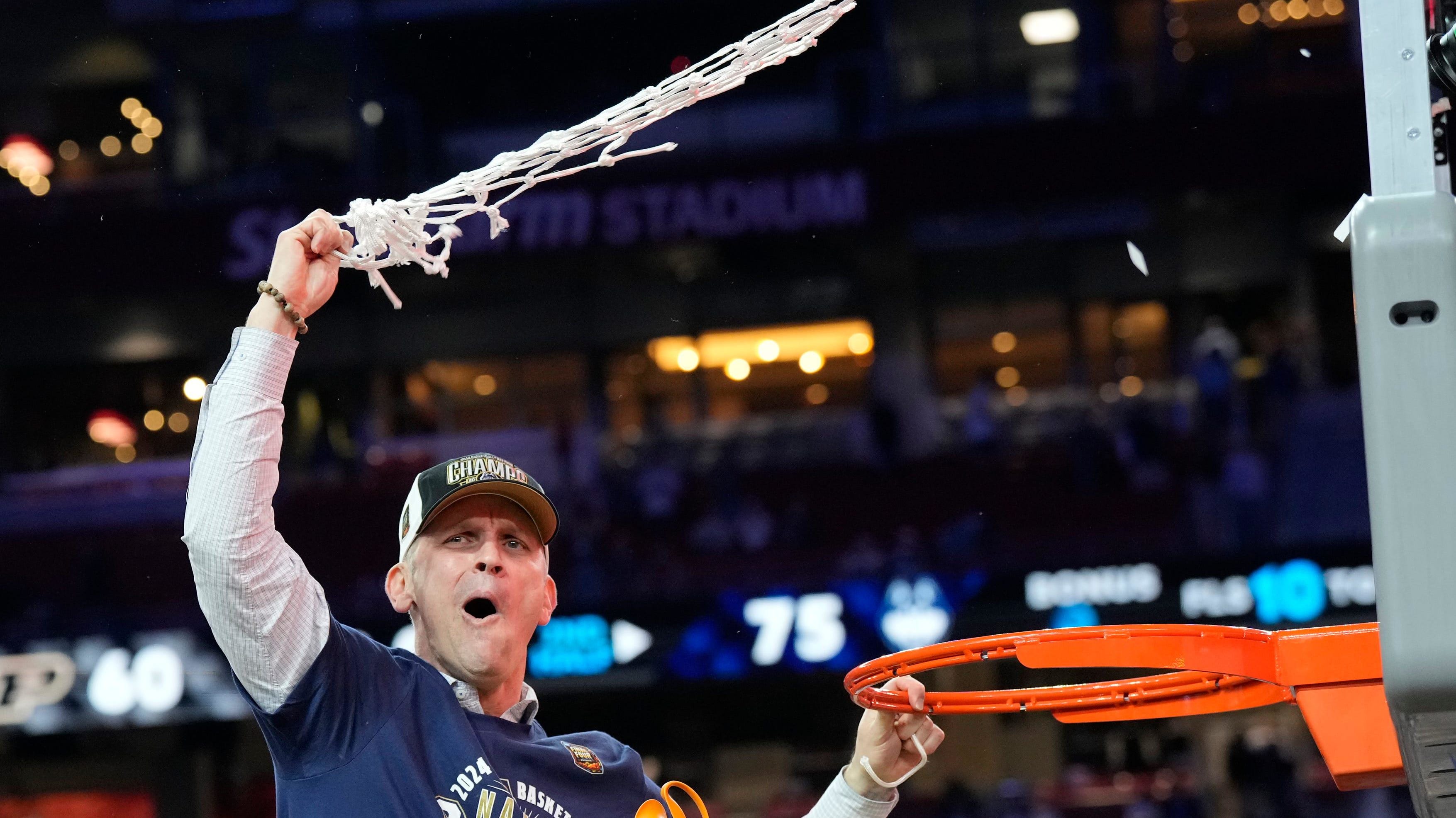 Hurley cuts down the nets after winning the national championship.