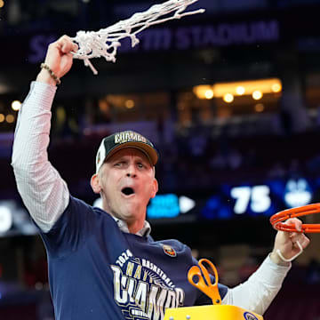 Connecticut Huskies head coach Dan Hurley cuts the basketball net winning the Men's NCAA national championship game against the Purdue Boilermakers at State Farm Stadium in Glendale on April 8, 2024.