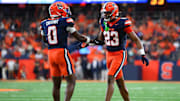 Aug 31, 2024; Syracuse, New York, USA; Syracuse Orange defensive back Devin Grant (23) celebrates with defensive back Duce Chestnut (0) after a play against the Ohio Bobcats during the second half at the JMA Wireless Dome. Mandatory Credit: Rich Barnes-Imagn Images