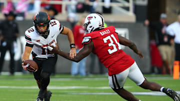 Oct 25, 2025; Lubbock, Texas, USA; Texas Tech Red Raiders defensive end David Bailey (31) pressures  Oklahoma State Cowboys quarterback Noah Walters (12) in the second half at Jones AT&T Stadium. Mandatory Credit: Michael C. Johnson-Imagn Images