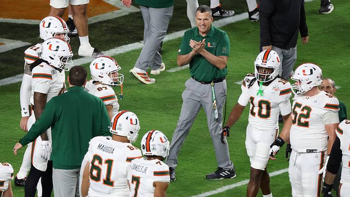 Jan 19, 2026; Miami Gardens, FL, USA; Miami Hurricanes head coach Mario Cristobal speaks to his players during warmups prior to the College Football Playoff National Championship game against the Indiana Hoosiers at Hard Rock Stadium. Mandatory Credit: Kim Klement Neitzel-Imagn Images