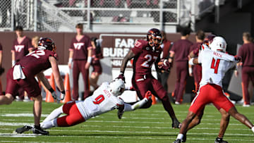Nov 1, 2025; Blacksburg, Va.; Virginia Tech running back Marcellous Hawkins (27) runs after a catch as Louisville defensive back Antonio Watts (9) attempts to tackle.