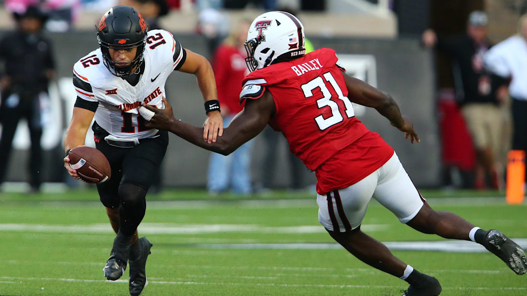 Oct 25, 2025; Lubbock, Texas, USA; Texas Tech Red Raiders defensive end David Bailey (31) pressures  Oklahoma State Cowboys quarterback Noah Walters (12) in the second half at Jones AT&T Stadium. Mandatory Credit: Michael C. Johnson-Imagn Images