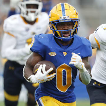 Aug 31, 2024; Pittsburgh, Pennsylvania, USA;  Pittsburgh Panthers running back Desmond Reid (0) runs on his way to scoring a touchdown against the Kent State Golden Flashes during the third quarter at Acrisure Stadium. Pittsburgh won 55-24. Mandatory Credit: Charles LeClaire-Imagn Images