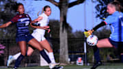 Lake Mary senior forward Anna Voigt (middle) watches her shot slide past Palm Harbor goalkeeper Keely Cash for a game-tying goal while freshman defender Alivia Gyasi (18) blocks and watches during a Class 7A girls soccer state semi final on Monday at Lake Myrtle Sports Complex.
