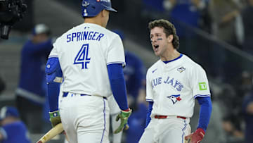 Nov 1, 2025; Toronto, Ontario, CAN; Toronto Blue Jays third baseman Ernie Clement (22) celebrates with right fielder George Springer (4) after scoring in the sixth inning during game seven of the 2025 MLB World Series at Rogers Centre 