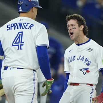 Nov 1, 2025; Toronto, Ontario, CAN; Toronto Blue Jays third baseman Ernie Clement (22) celebrates with right fielder George Springer (4) after scoring in the sixth inning during game seven of the 2025 MLB World Series at Rogers Centre 
