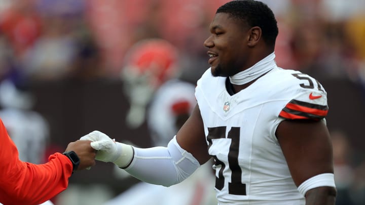 Cleveland Browns defensive tackle Mike Hall Jr. (51) shakes hands with a coach before an NFL preseason football game at Cleveland Browns Stadium, Saturday, Aug. 17, 2024, in Cleveland, Ohio.