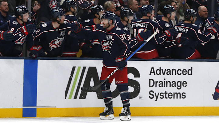 Blue Jackets captain Boone Jenner celebrates a goal with his teammates.