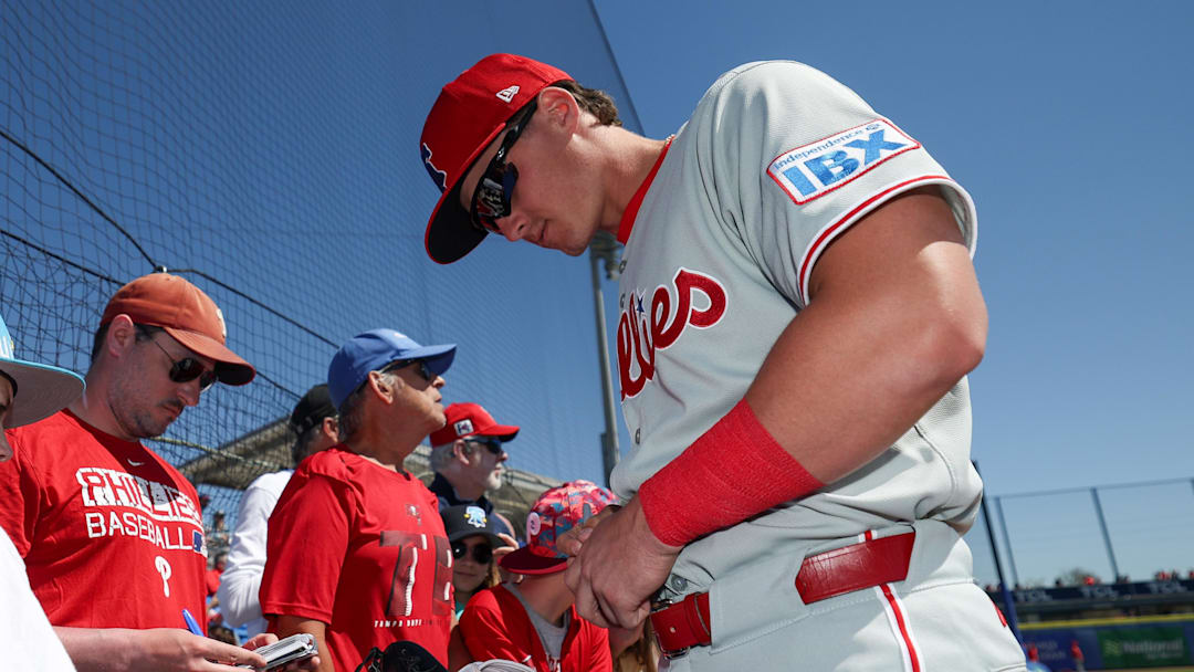 Mar 2, 2025; Dunedin, Florida, USA; Philadelphia Phillies infielder Aidan Miller (81) signs autographs for fans before a game against the Toronto Blue Jays during spring training at TD Ballpark. Mandatory Credit: Nathan Ray Seebeck-Imagn Images