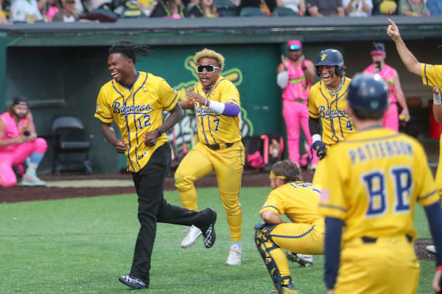 Heisman trophy winner Travis Hunter runs off the field after dancing with the Bananas during the Savannah Bananas game on Fri