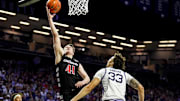 Dec 30, 2024; Manhattan, Kansas, USA; Cincinnati Bearcats guard Simas Lukosius (41) shoots against Kansas State Wildcats guard Coleman Hawkins (33) during the first half at Bramlage Coliseum. Mandatory Credit: Jay Biggerstaff-Imagn Images