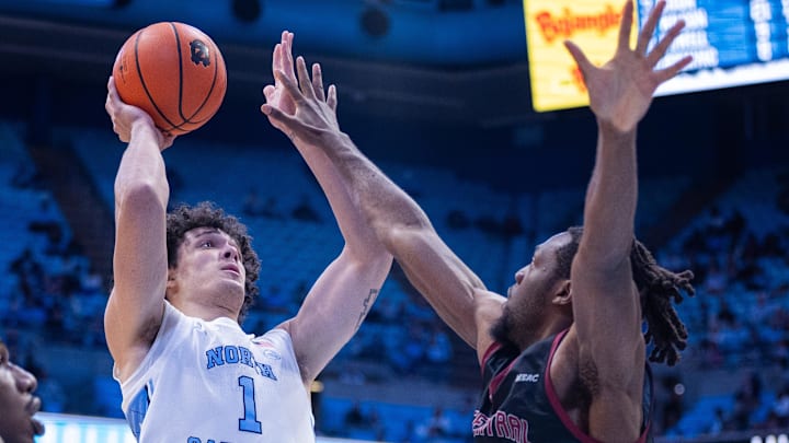 Nov 14, 2025; Chapel Hill, North Carolina, USA; North Carolina Tar Heels forward Zayden High (1) shoots on North Carolina Central Eagles forward Kelechi Okworogwo (21) during the second half at Dean E. Smith Center. Mandatory Credit: Scott Kinser-Imagn Images