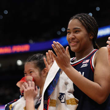 UConn Huskies forward Sarah Strong and guard Paige Bueckers react to a play on the bench during the Final Four.