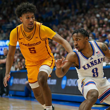 Feb 3, 2025; Lawrence, Kansas, USA; Kansas Jayhawks guard David Coit (8) dribbles the ball against Iowa State Cyclones guard Curtis Jones (5) during the second half at Allen Fieldhouse. Mandatory Credit: Jay Biggerstaff-Imagn Images