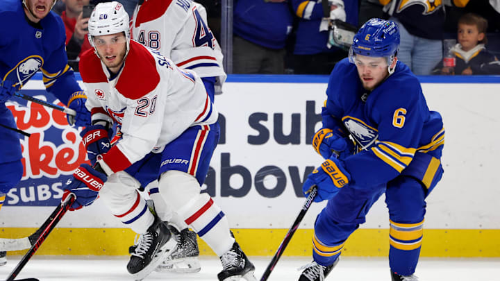 May 6, 2026; Buffalo, New York, USA; Montréal Canadiens left wing Juraj Slafkovský (20) watches as Buffalo Sabres left wing Zach Benson (6) clears the puck during the third period in game one of the second round of the 2026 Stanley Cup Playoffs at KeyBank Center. Mandatory Credit: Timothy T. Ludwig-Imagn Images