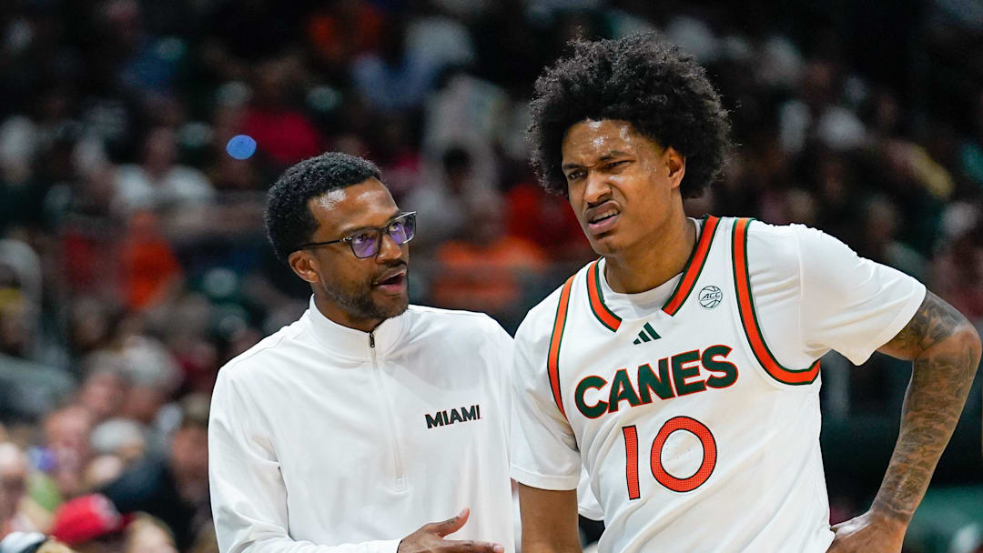 Mar 7, 2026; Coral Gables, Florida, USA; Miami Hurricanes head coach Jai Lucas talks to guard Tru Washington (10) after a foul against the Louisville Cardinals during the second half at Watsco Center. Mandatory Credit: Jeff Romance-Imagn Images