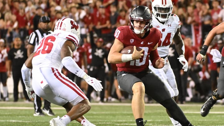 Sep 9, 2023; Pullman, Washington, USA; Washington State Cougars quarterback John Mateer (10) carries the ball against Wisconsin Badgers safety Travian Blaylock (26) in the second half at Gesa Field at Martin Stadium. Washington State won 31-22. Mandatory Credit: James Snook-USA TODAY Sports