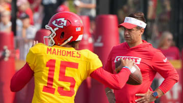 Jul 26, 2024; Kansas City, MO, USA; Kansas City Chiefs quarterback Patrick Mahomes (15) throws a pass as general manager Brett Veach watches in the background during training camp at Missouri Western State University. Mandatory Credit: Denny Medley-Imagn Images