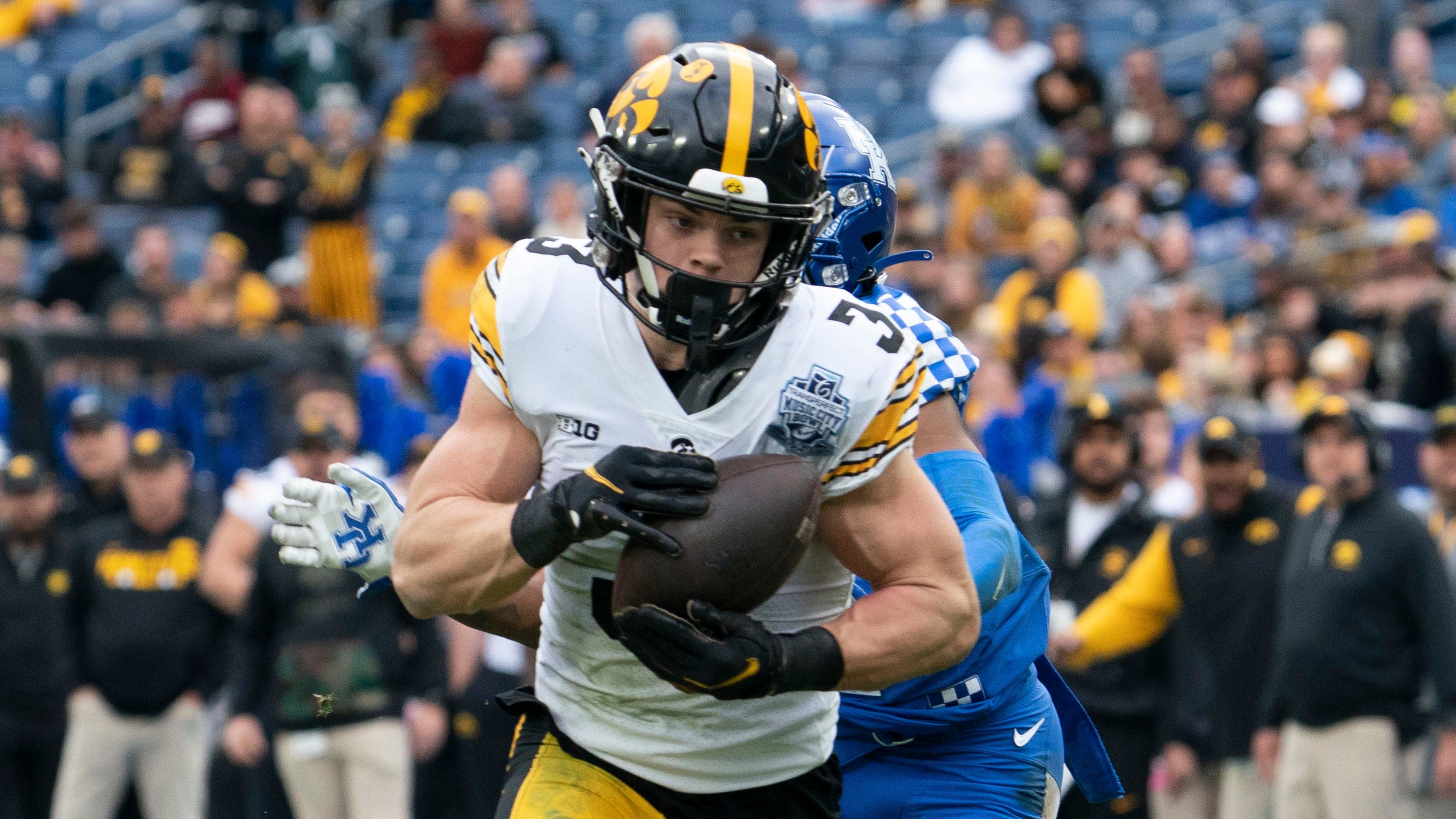 Iowa defensive back Cooper DeJean (3) pulls in an interception for a touchdown over a Kentucky wide receiver