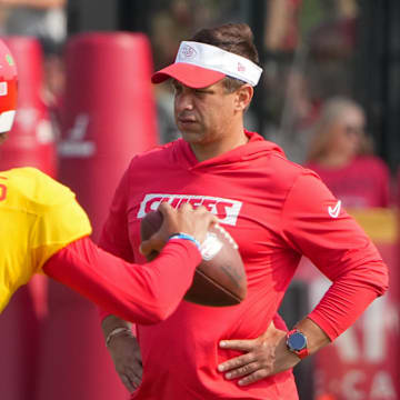 Jul 26, 2024; Kansas City, MO, USA; Kansas City Chiefs quarterback Patrick Mahomes (15) throws a pass as general manager Brett Veach watches in the background during training camp at Missouri Western State University. Mandatory Credit: Denny Medley-Imagn Images